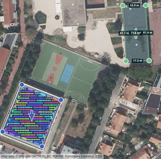 An aerial photograph with two outlined zones: a long flat-roofed building labelled with its four wall lengths, about 17 and 42 metres, and its area of 714 square metres in the middle; and, south-west of it, a sports-hall roof packed with coloured modules and a white arrow pointing south.